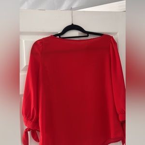 Red blouse with tied sleeves